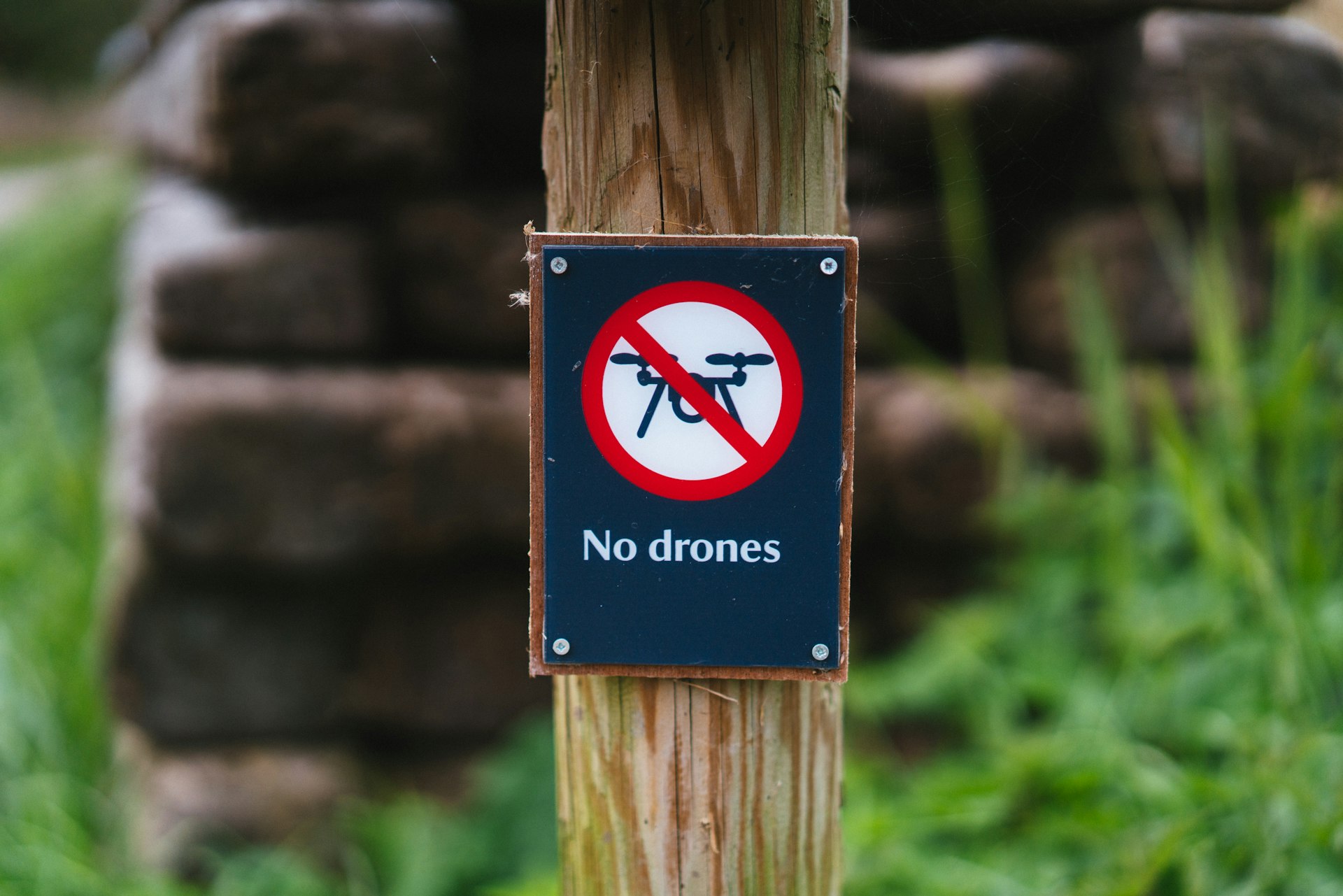 a sign is posted on a wooden post